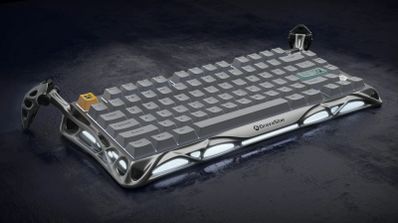 Teclado mecánico GravaStar Mercury K1 Pro en color gris, mostrando su diseño futurista con estructura de aluminio y patas externas para ajustar la inclinación.