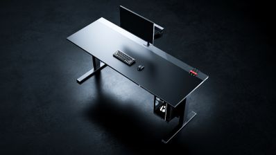Mesa elevable para gaming Secretlab MAGNUS Evo en color negro, mostrando su superficie completa con un setup de ordenador y su sistema de gestión de cables integrado.Mesa elevable para gaming Secretlab MAGNUS Evo en color negro, mostrando su superficie completa con un setup de ordenador y su sistema de gestión de cables integrado.