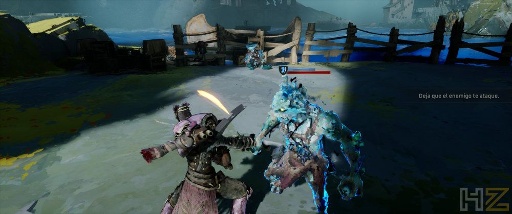 Combate en Elta Defy All Gods entre un guerrero y una criatura de aura azul en un entorno costero.