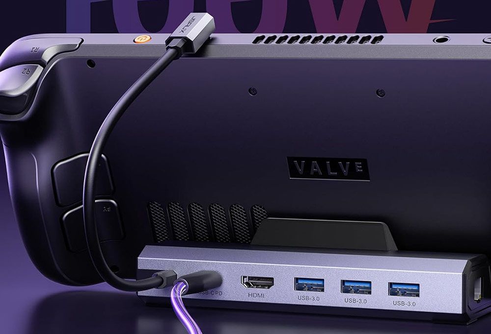 Parte trasera de una consola Steam Deck conectada a una base JSAUX con puertos USB y HDMI.