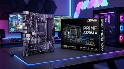 Placa base ASUS PRIME A320M fuera de su caja sobre un escritorio con iluminación LED.