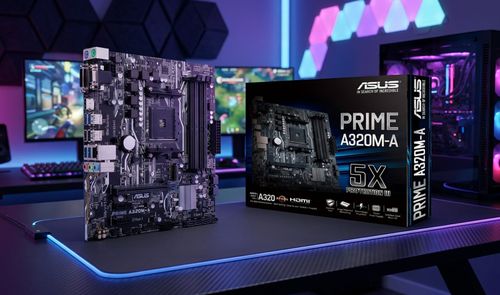 Placa base ASUS PRIME A320M fuera de su caja sobre un escritorio con iluminación LED.