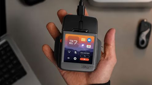 Ratón artic fox super mouse con pantalla integrada que muestra iconos de aplicaciones y widgets de sistema.
