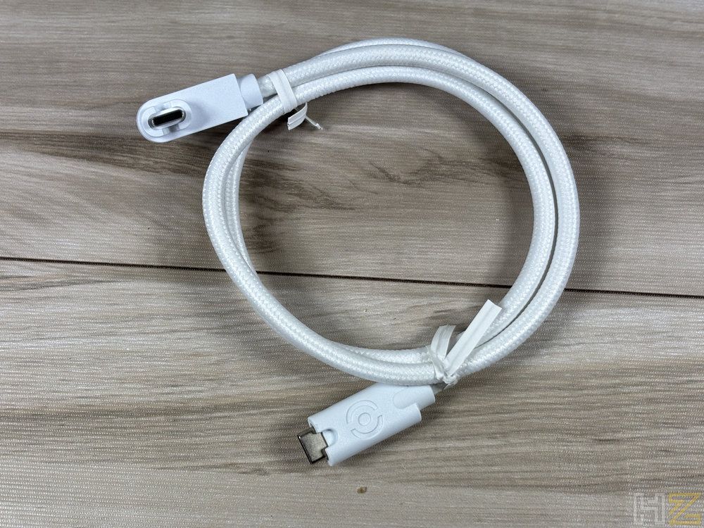 Cable de conexión blanco para ventiladores be quiet! Light Wings Pro enrollado sobre una superficie de madera.