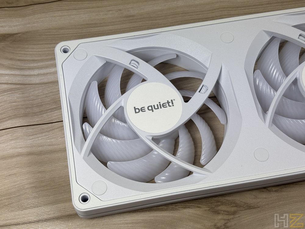 Primer plano de la parte posterior de un ventilador blanco be quiet! Light Wings Pro donde se aprecia el eje central y las aspas.