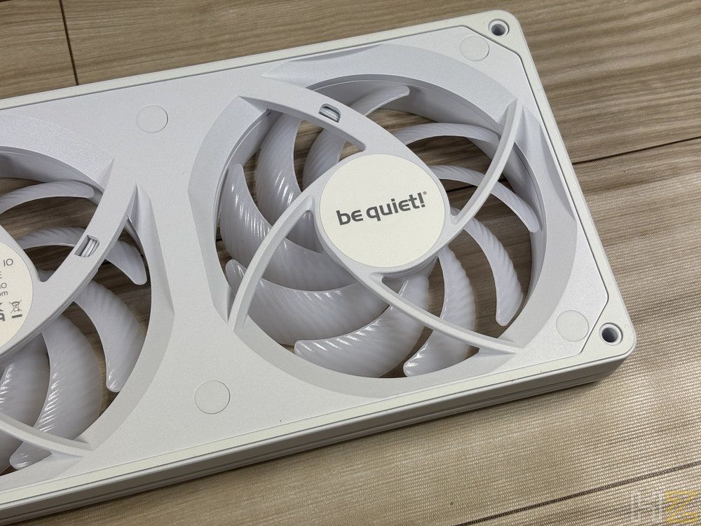 Primer plano de los ventiladores be quiet! Light Wings Pro IO 24 en color blanco sobre una superficie de madera.